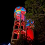Artistic projection and lighting adorn the Goondiwindi MacLean Street water tower in multiple hues.