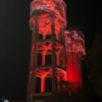 Artistic projection featuring Connective Tissue Disorder themed artwork atop the Goondiwindi MacLean Street water tower featured during May 2025 as part of a community initiative.