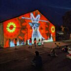 The Cool kangaroo in pixellated sunglasses encourages children to dance in the rich light of the projections.